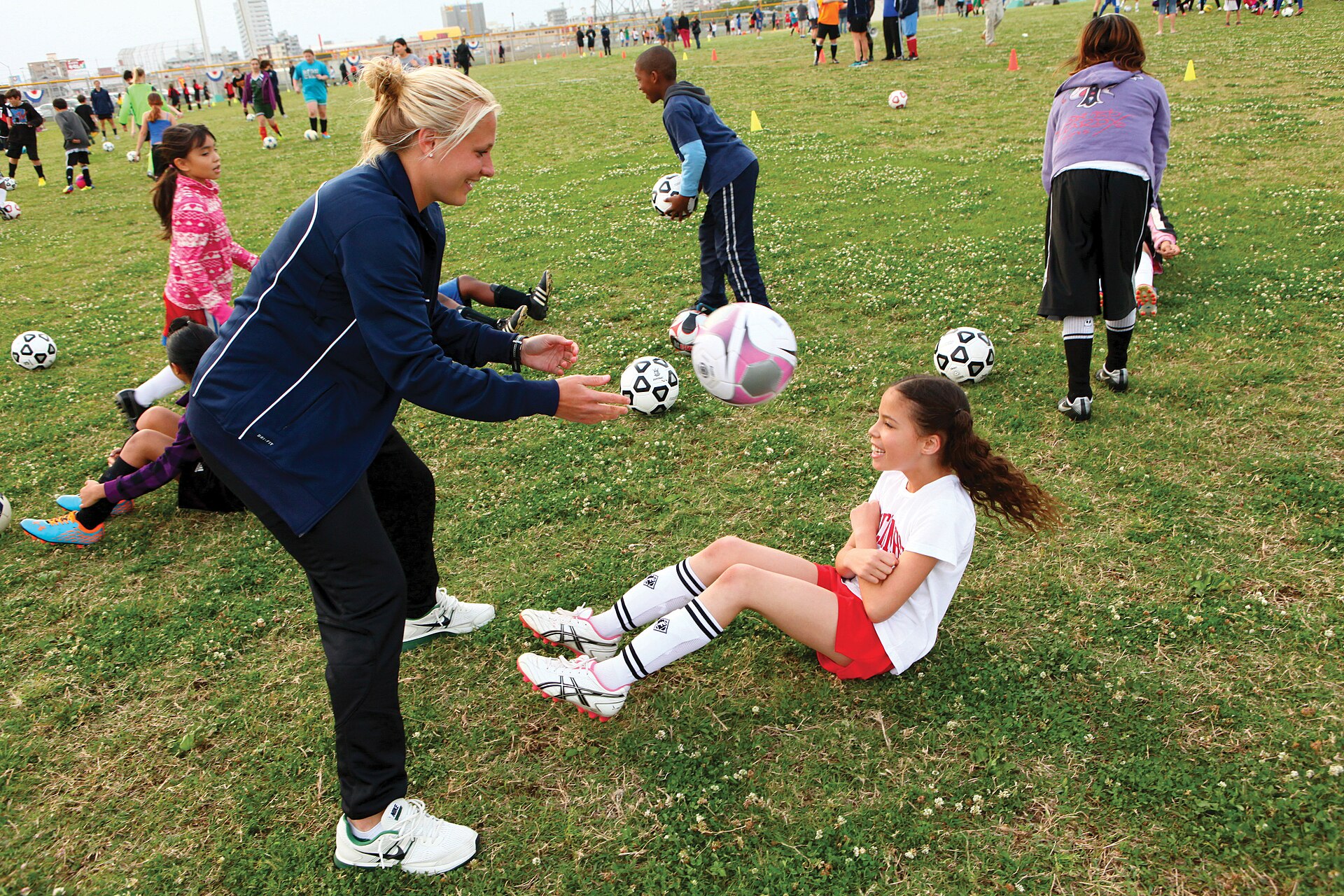 Children practising close football control during a youth clinic