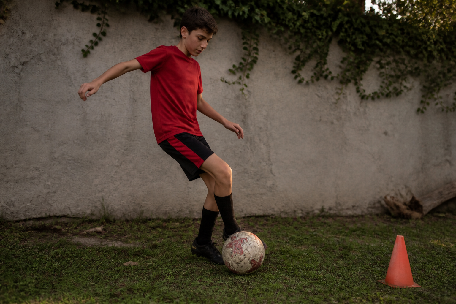 Young football player controlling the ball during first-touch practice