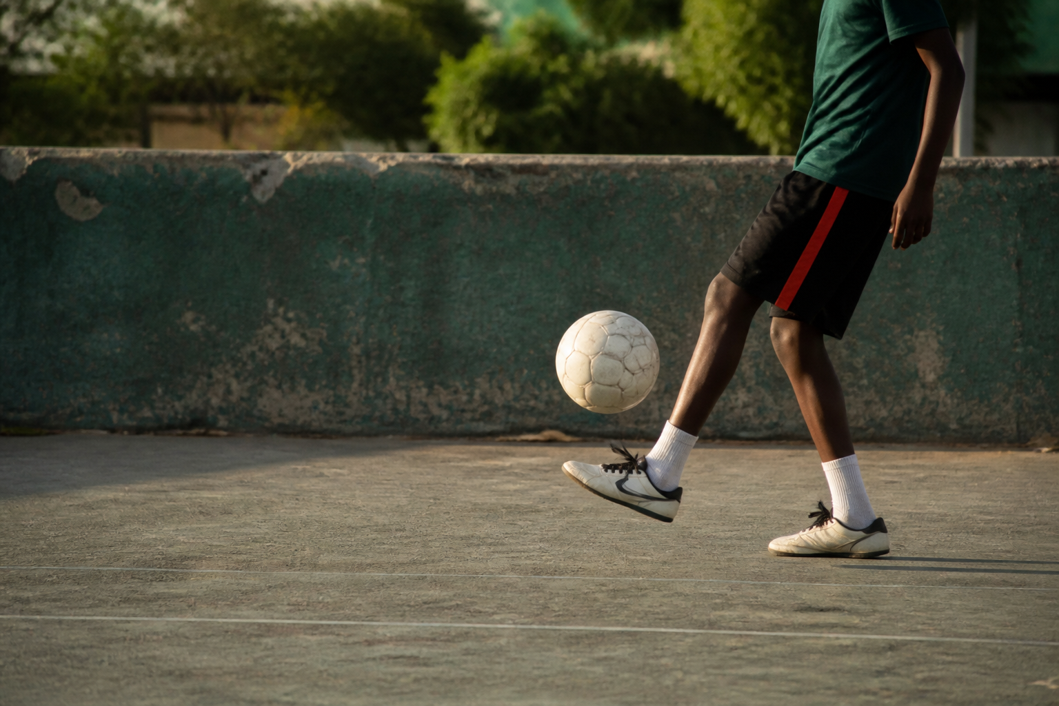 Young football player receiving a pass during practice