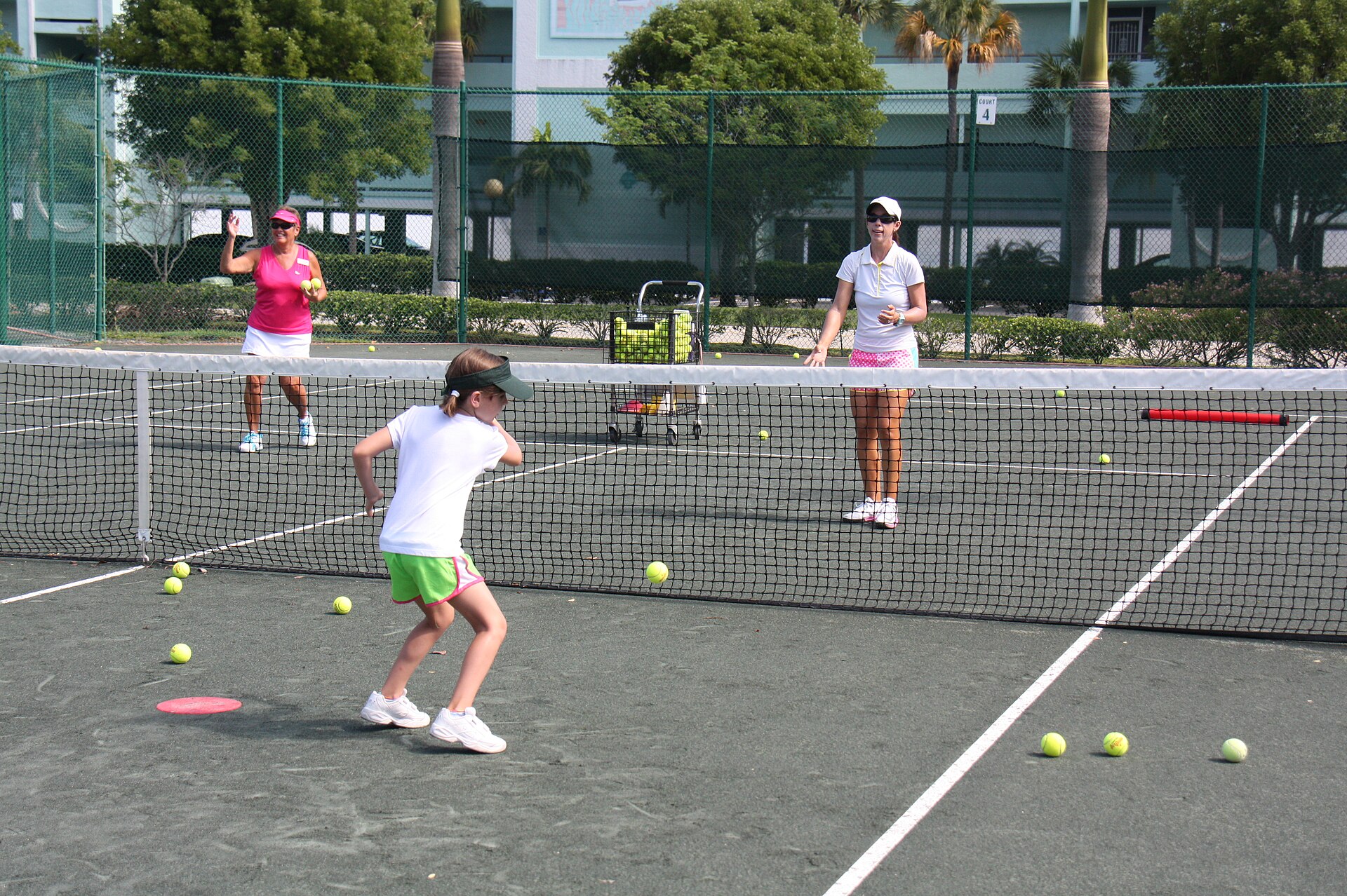Child preparing to meet a gently fed tennis ball during a supervised practice